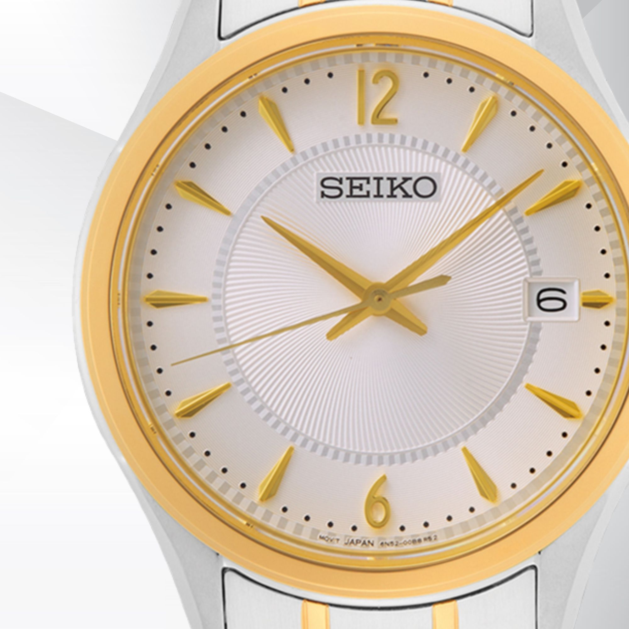 Zegarek Seiko z jasną tarczą z indeksami i wskazówkami w złotym kolorze oraz datownikiem przy godzinie trzeciej