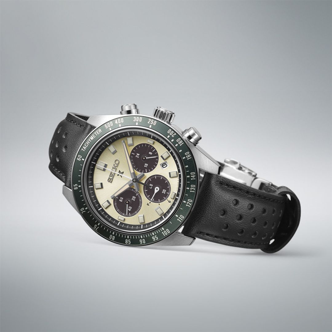 Zegarek Seiko ze złotą tarczą z czarnymi subtarczami chronografu oraz datownikiem w kopercie z zieloną lunetą tachymetru