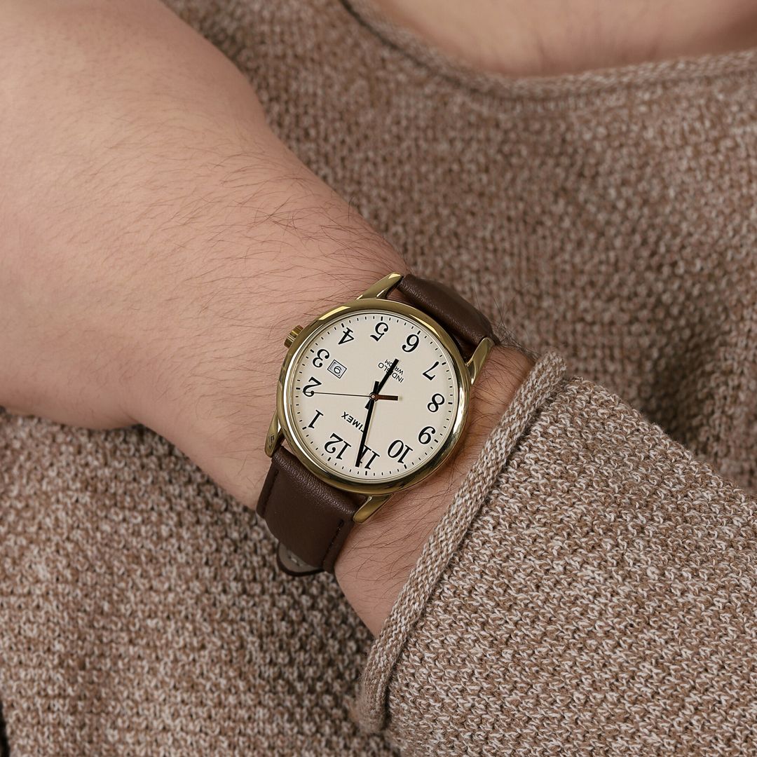Zegarek Timex z okrągłą kopertą w złotym odcieniu oraz brązowym, skórzanym paskiem