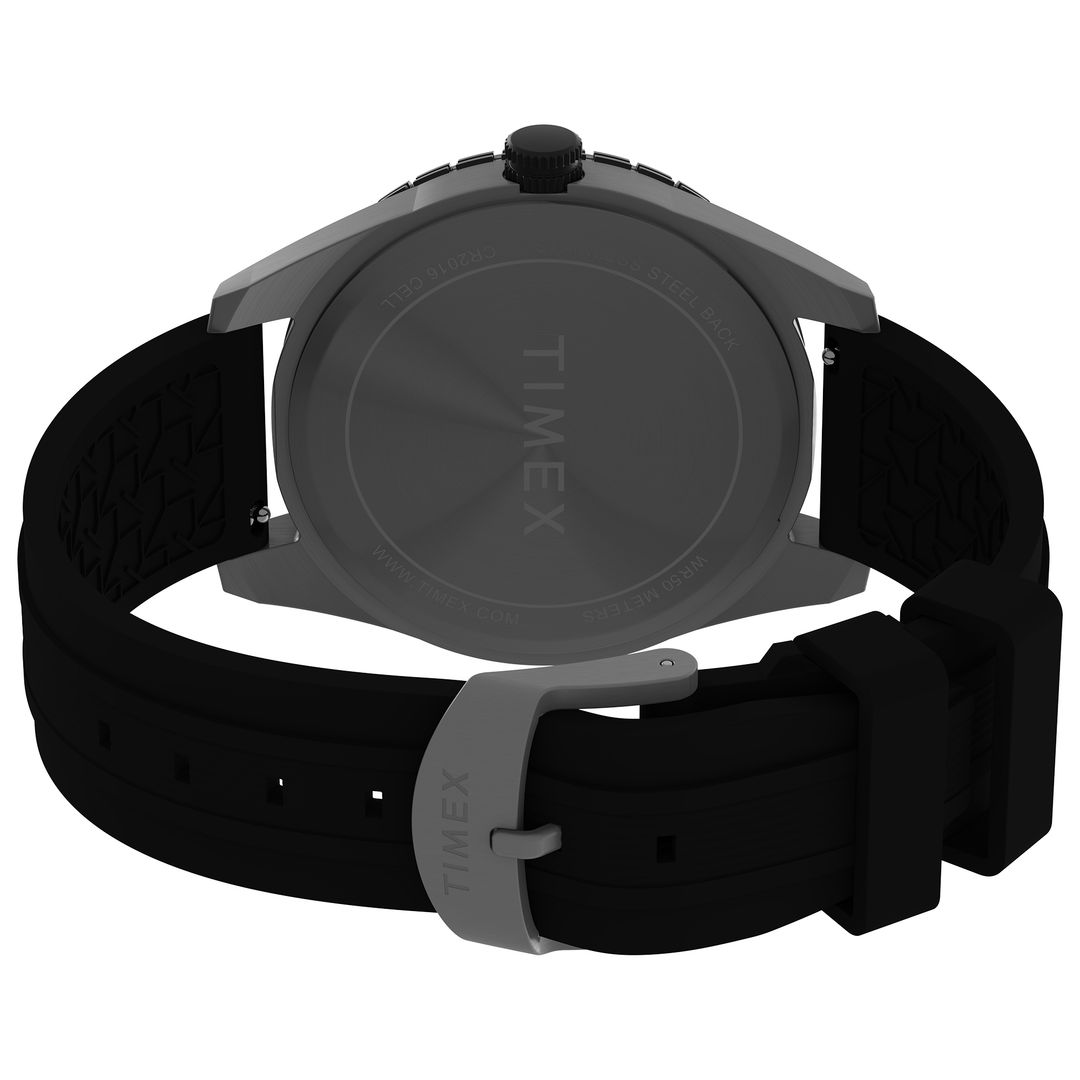 Zapięcie i dekielek zegarka marki Timex z zapięciem na sprzączkę oraz czarnym paskiem